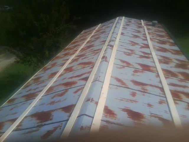 Rusted metal roof panels with new wood purlins before replacement — Storm Damage Roof Repair in Copperhill by Roofing Brothers