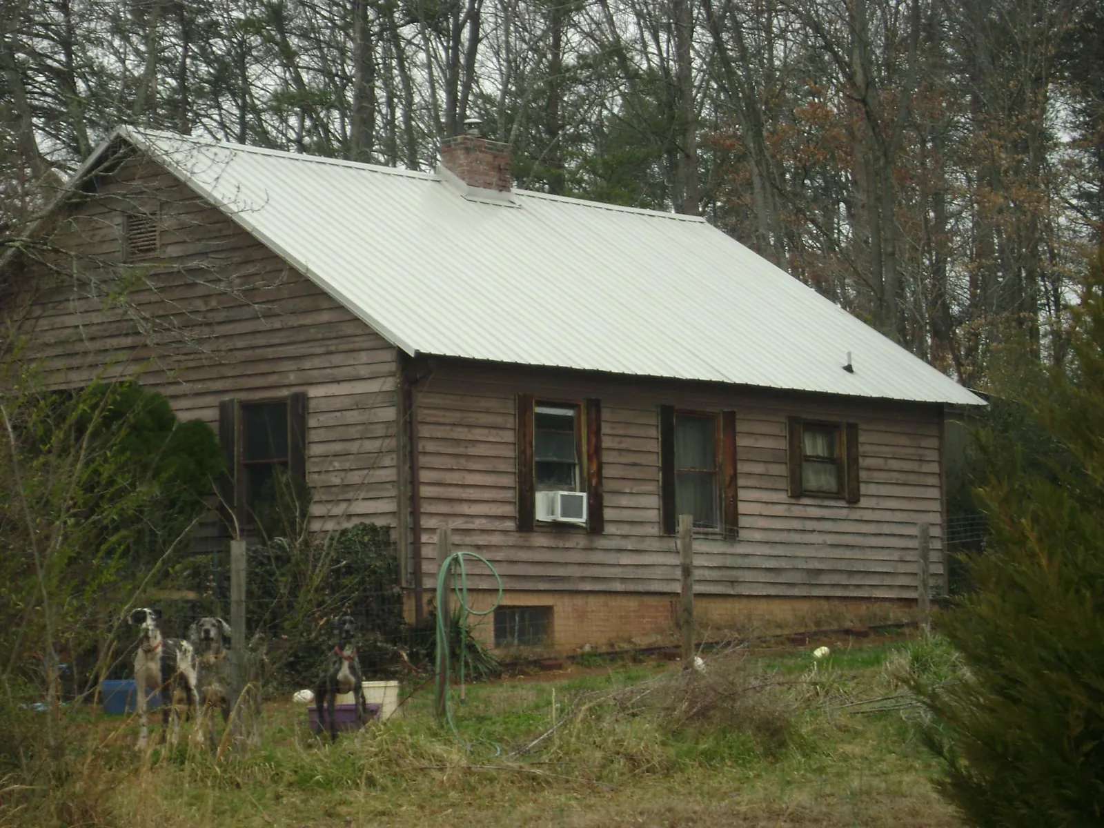 White metal roof on an old wood sided farmhouse, from a Metal Roof Installation job in Copperhill